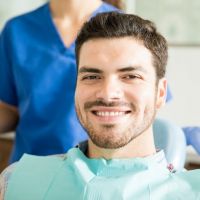 Smiling bearded man in dental chair