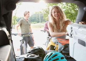 Friends packing Jeep for bicycle trip